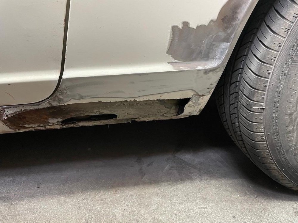 passenger dogleg rust hole.jpg